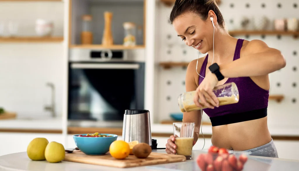 Woman making protein shake after exercise.
