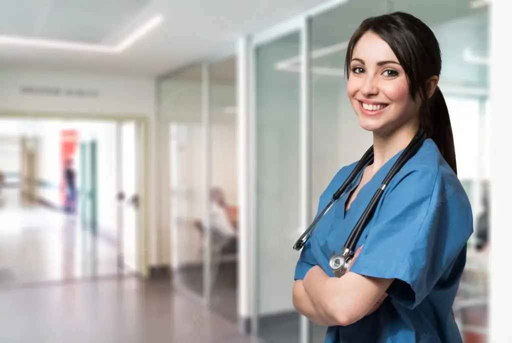 In a close-up shot, a female doctor smiles at the camera