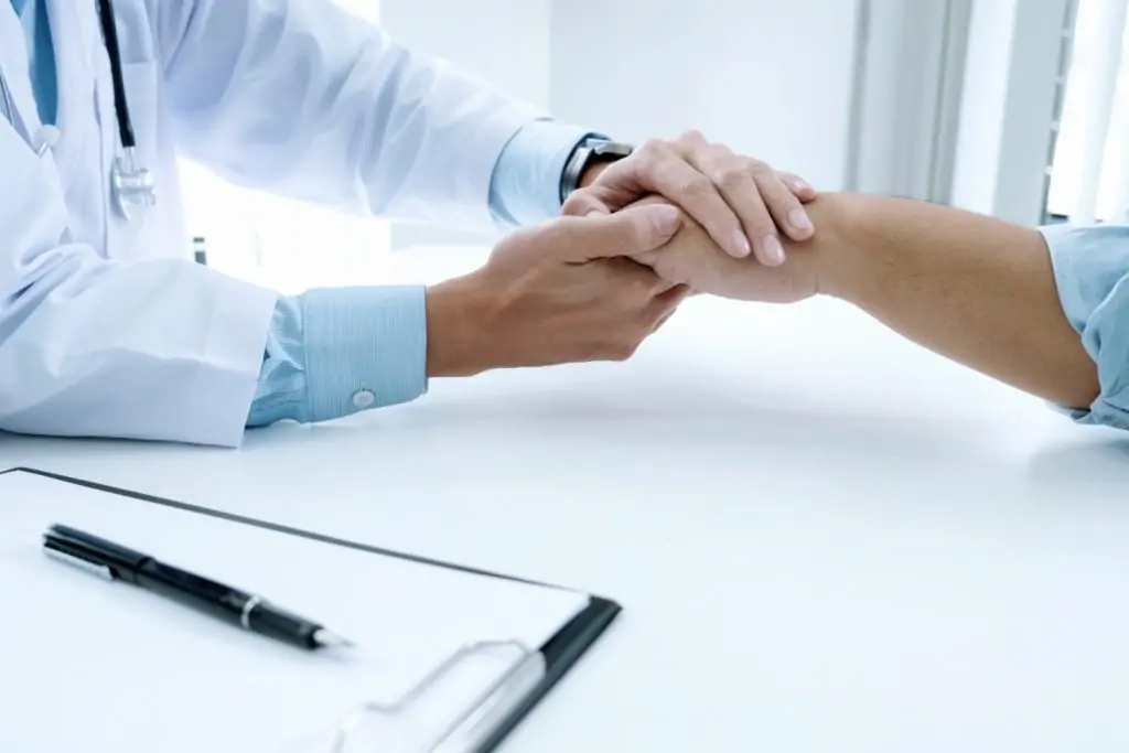 doctor holding patient hand
