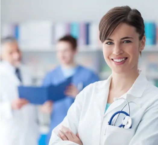 In a close-up shot, a female doctor smiles at the camera