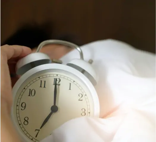 Hand holding clock