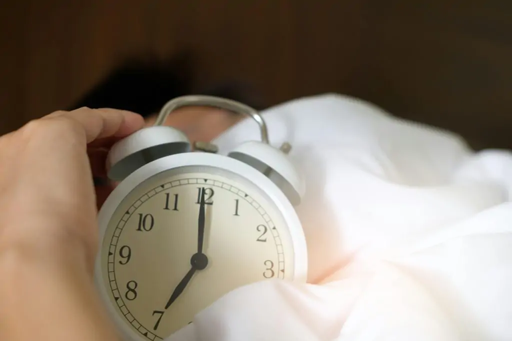 Hand holding clock