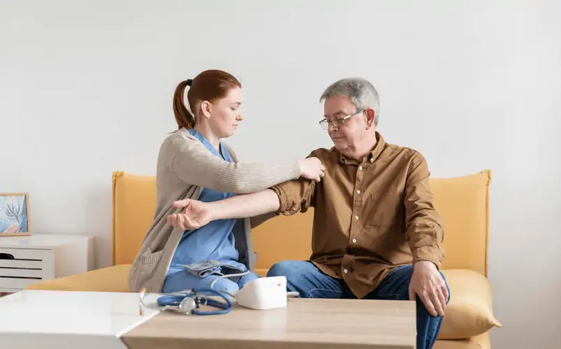 A personal nurse checks blood pressure