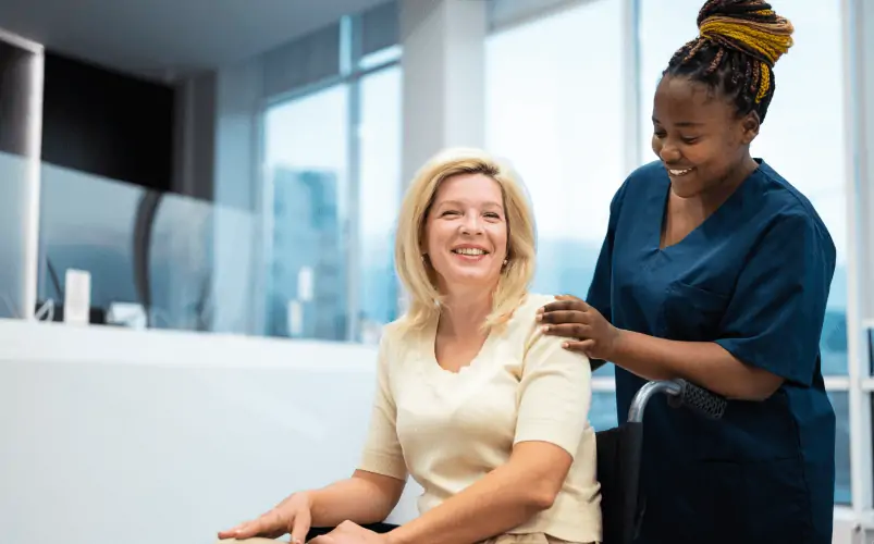 Black female caregiver talking to dementia patient